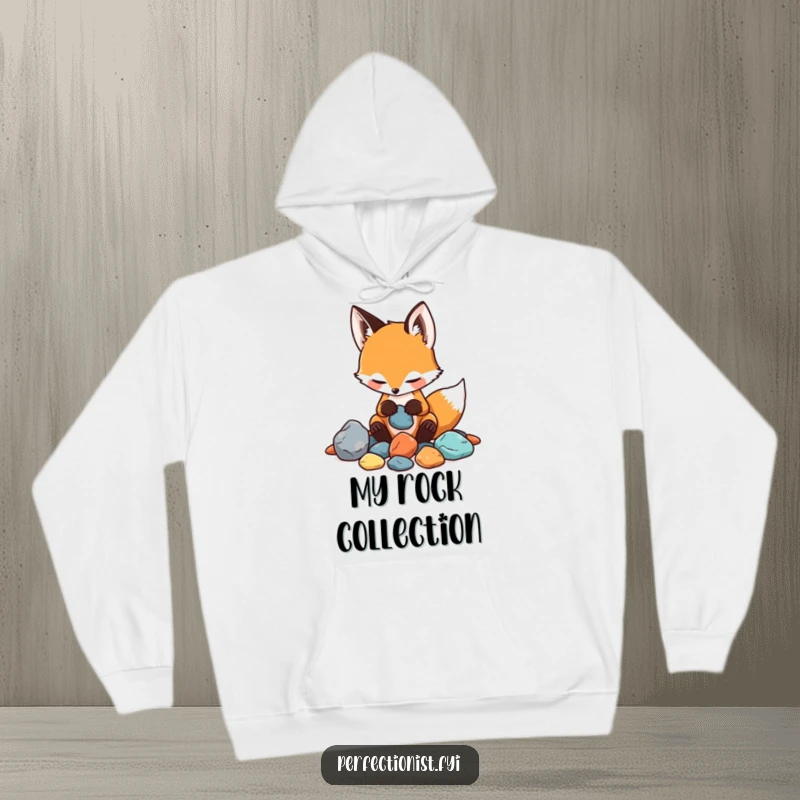 Funny hoodie displaying a playful fox carefully categorizing rocks by their visual and tactile qualities, a comical collector.